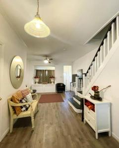 a living room with a staircase and a couch at 2bd Spacious S. Philly Row-House, Wi-Fi & 1.5 bath in Philadelphia
