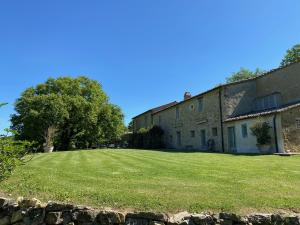 a large grassy yard next to a building at L'ocanda Rancioli in San Casciano dei Bagni