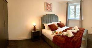 リバプールにあるThe Comfy Flat- Modern & Bright 2 Bedrooms Apartmentのベッドルーム1室(ベッド1台、食料品のトレイ付)