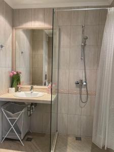 a bathroom with a shower and a sink at Deluxe Apartment Varna South Bay Beach Residence in Varna City