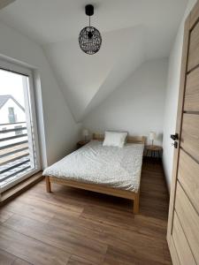 Postel nebo postele na pokoji v ubytování Piaski Morza