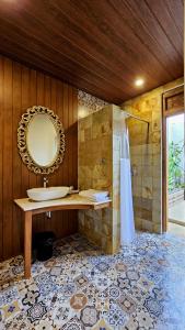 a bathroom with a sink and a mirror at Jepara Garden Resort in Jepara