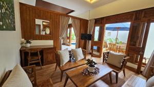 a living room with a table and chairs at Jepara Garden Resort in Jepara