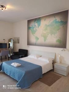 a bedroom with a bed with a map on the wall at Casa DOLCE PUGLIA Melograno in Castellana Grotte