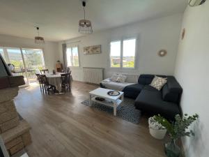 a living room with a couch and a table at Villa avec piscine dans Vallon Pont d’Arc in Vallon-Pont-dʼArc