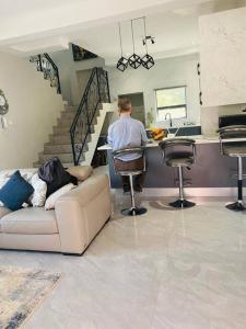 een persoon die op een bank in een woonkamer ligt bij modern, two-story luxury house in Gaborone