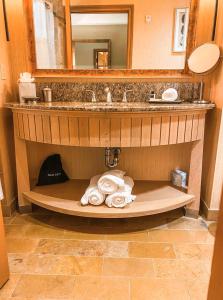 a bathroom with a sink and towels on a shelf at Suncadia Lodge Studio Unit in Cle Elum