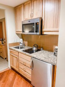 a kitchen with a sink and a microwave at Suncadia Lodge Studio Unit in Cle Elum
