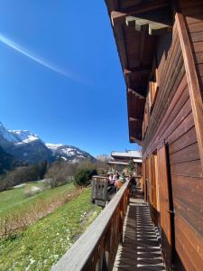 a wooden walkway between two buildings with mountains in the background at Chalet Villars-Gryon 8pax Cosy in Gryon