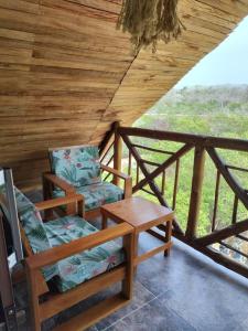 dwa krzesła i stół na ganku w obiekcie Hotel Calamari Baru w mieście Playa Blanca