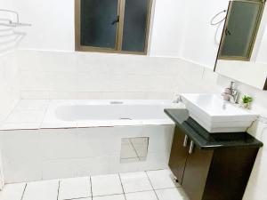 a bathroom with a white tub and a sink at Midrand Siena Sun Luxury Suites 3 with water reserve in Midrand