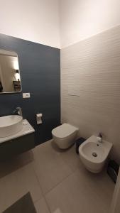 a bathroom with a white toilet and a sink at Casetta San Giorgio in Vallata