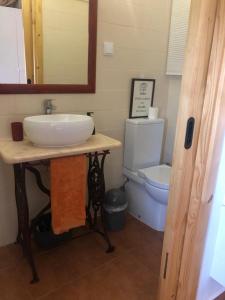 a bathroom with a sink and a toilet at 10 da Muralha in Estremoz +44 photos