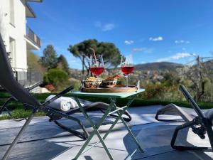 a table with two glasses of wine and food on it at i FAGGI ROSSI - RED BEECH TREES in Como