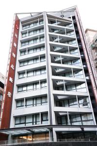 a tall white apartment building with balconies at Royal Jade Boutique Hotel in Taipei