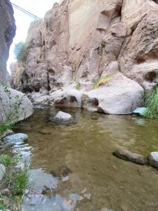 a river in a canyon with rocks in the water at Alojamiento casa en Toconao, chile in Toconao