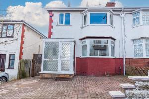 a white and red house with a large door at Beautiful 3 bedroom House near West Bromwich -contractors, Family, NHS 