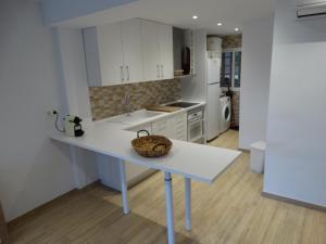 a kitchen with a table with a basket on it at Falcon (Beach & Golf) in Playa de San Juan