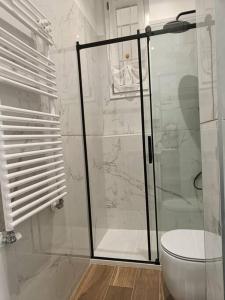 a bathroom with a glass shower with a toilet at Lucania25 in Milan