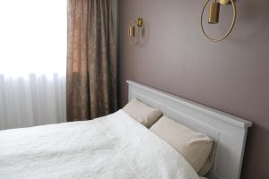 Postel nebo postele na pokoji v ubytování Pihtla tee külaliskorter 4