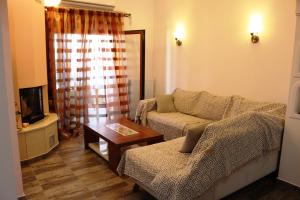 a living room with a couch and a table at Evilio in Alonnisos Old Town