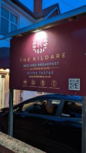 a car parked under a sign in front of a building at The Kildare in Skegness