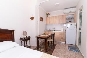 een keuken met een bed, een tafel en een koelkast bij ERLA'S apartment in Tirana