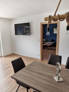 a dining room with a table and chairs and a mirror at Berg:Zeit_Apartments in Tamsweg