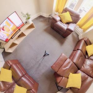 an overhead view of a living room with two brown leather chairs at Contractor HQ Spacious & Central 4 Bed Home in Newcastle upon Tyne
