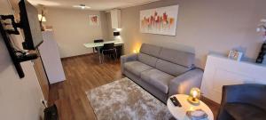 a living room with a couch and a table at Studio chaleureux avec parking gratuit in Vandoeuvre-lès-Nancy