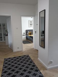 a living room with a bed and a mirror at Zaciszny Apartament Old Town Gdansk in Gdańsk