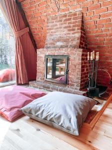 a brick walled bedroom with a bed and a mirror at Loca Sapanca Bungalov in Sapanca