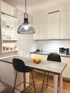 a kitchen with a table with oranges on it at LUMI Apartament Mokotów in Warsaw