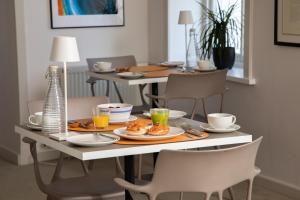 a dining room table with plates of food on it at Roskhill House in Dunvegan