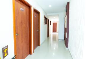 a hallway with a row of wooden doors in a building at Hotel Sierra Nevada in Santa Marta