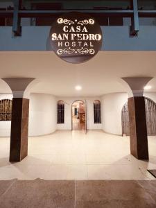 a large room with a sign hanging from the ceiling at Hostal Casa San Pedro in Santa Marta