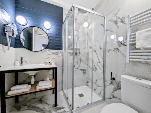 a bathroom with a shower and a sink at Hôtel Flor in Saint-Florent