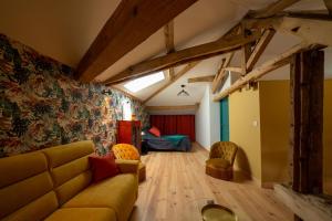 a living room with a couch and a bed at Le Clos Saint-Jean - Chambre d'hôte Scarlett in Saint-Jean-de-Thurac
