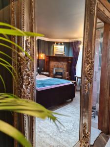 a bedroom with a bed and a mirror at Glencruitten House in Oban