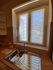 a kitchen with a sink and a window at Casa Lerici Holidays in Lerici