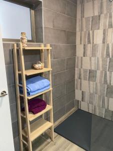 a bathroom with a shelf with towels on it at Villa Inda in Gran Tarajal