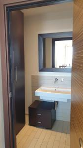a bathroom with a sink and a mirror at Cala Dei Mori in Livorno