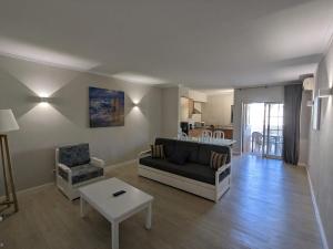 a living room with a couch and a table at VilaBplaza by JohnVillas in Alvor