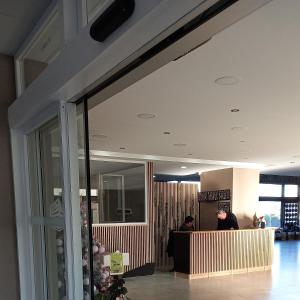 a lobby with a person sitting at a counter at Bariloche Center 630 STUDIO in San Carlos de Bariloche