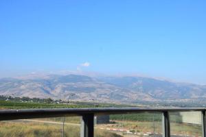 a view of a mountain range from a balcony at מול חרמון in Qiryat Shemona