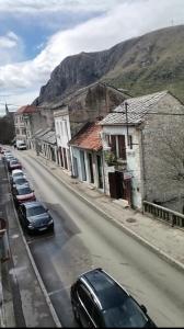 a street with cars parked on the side of a road at Apartments Stari most in Mostar