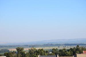 a view of the countryside from the roof of a building at מול חרמון in Qiryat Shemona