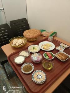 a table with plates of food on top of it at Plaza de petra in Wadi Musa