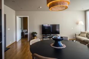 a living room with a table and a tv at S19 - Akureyri Prime Apart. in Akureyri