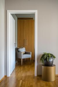 a living room with a chair and a potted plant at S19 - Akureyri Prime Apart. in Akureyri